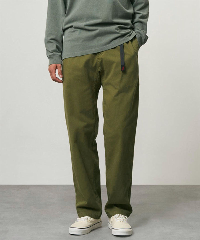 Model wearing olive Gramicci Pants and a green shirt on a light-tone background.