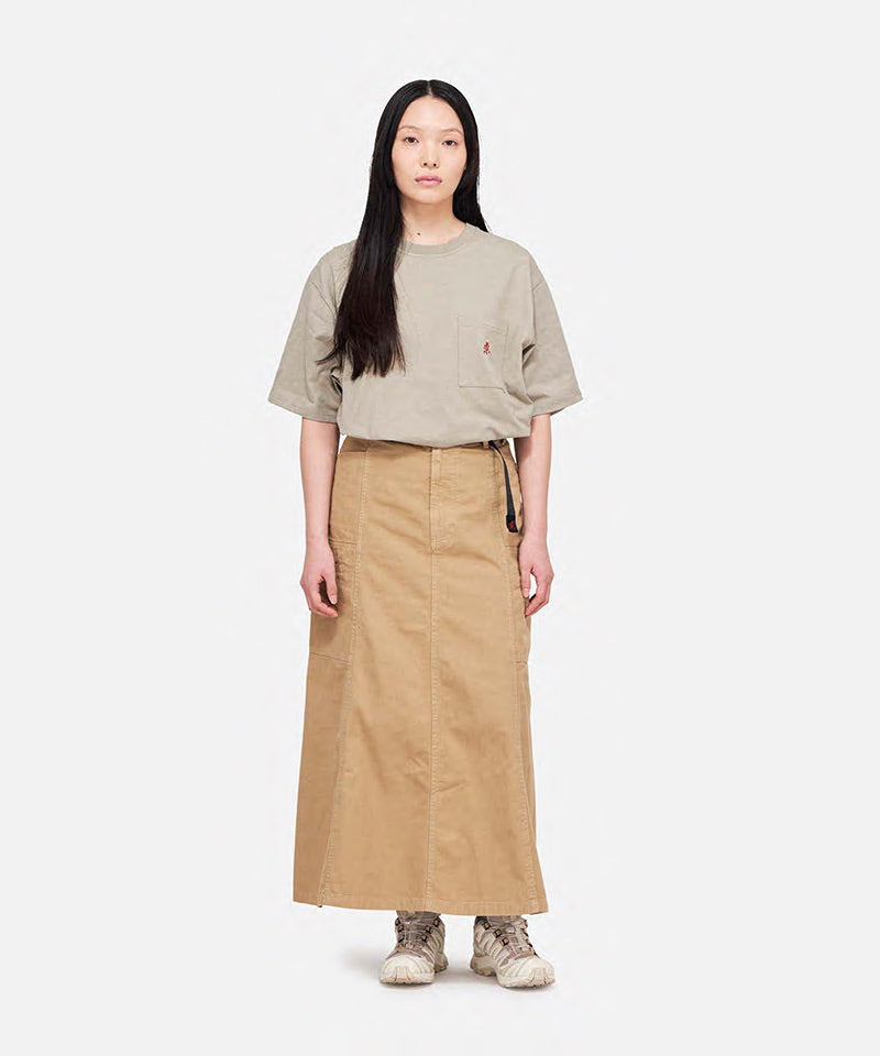 Full Model
Model wearing a khaki Gramicci One Point Tee with a small running man graphic and beige skirt on a light-tone background.