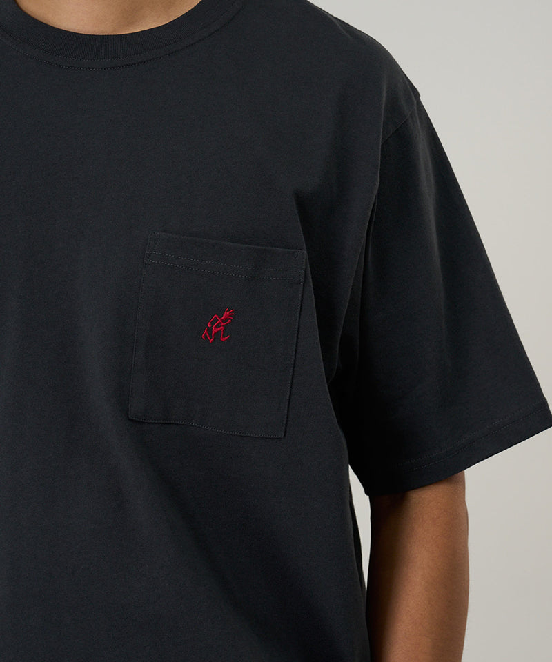 Model wearing a Gramicci vintage black One Point Tee with a small running man graphic against a light-tone background.