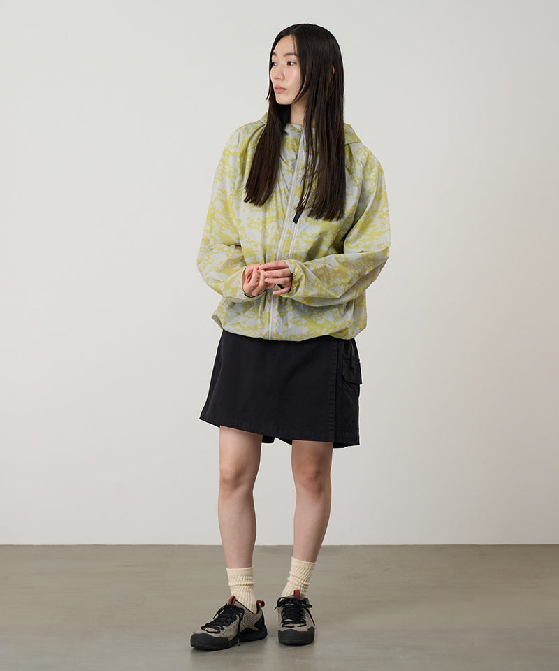 Model wearing a Gramicci G-Skort in the color black and a yellow patterned jacket on a light-tone background.