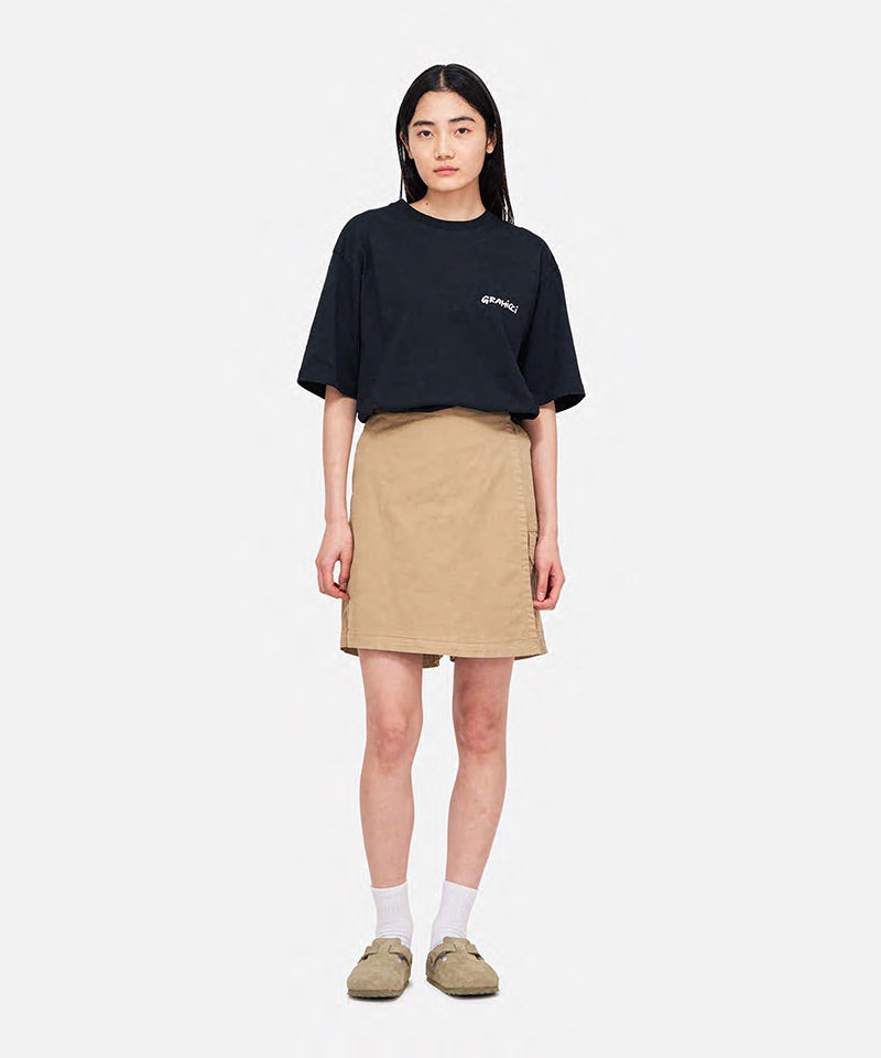 Model wearing a Gramicci G-Skort in the color chino and a black shirt on a light-tone background.