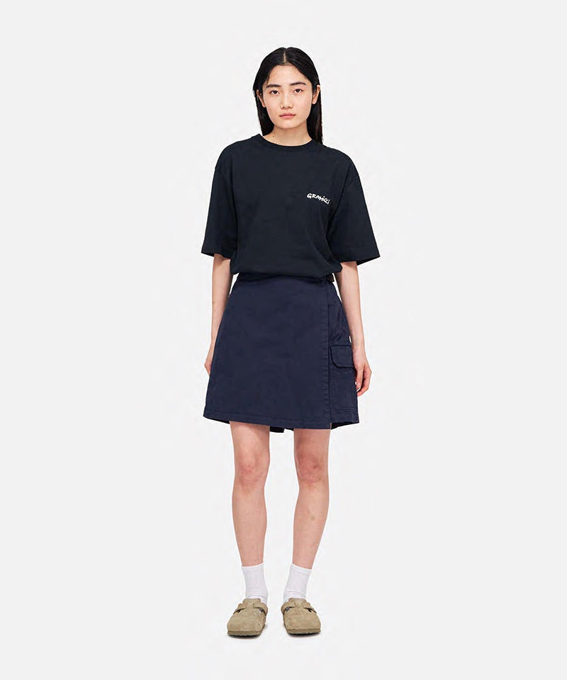 Model wearing a Gramicci G-Skort in the color double navy and a black shirt on a light-tone background.