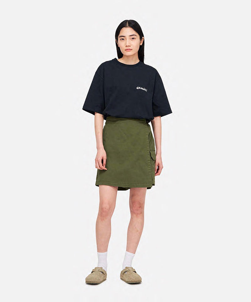 Model wearing a Gramicci G-Skort in the color olive and a black shirt on a light-tone background.