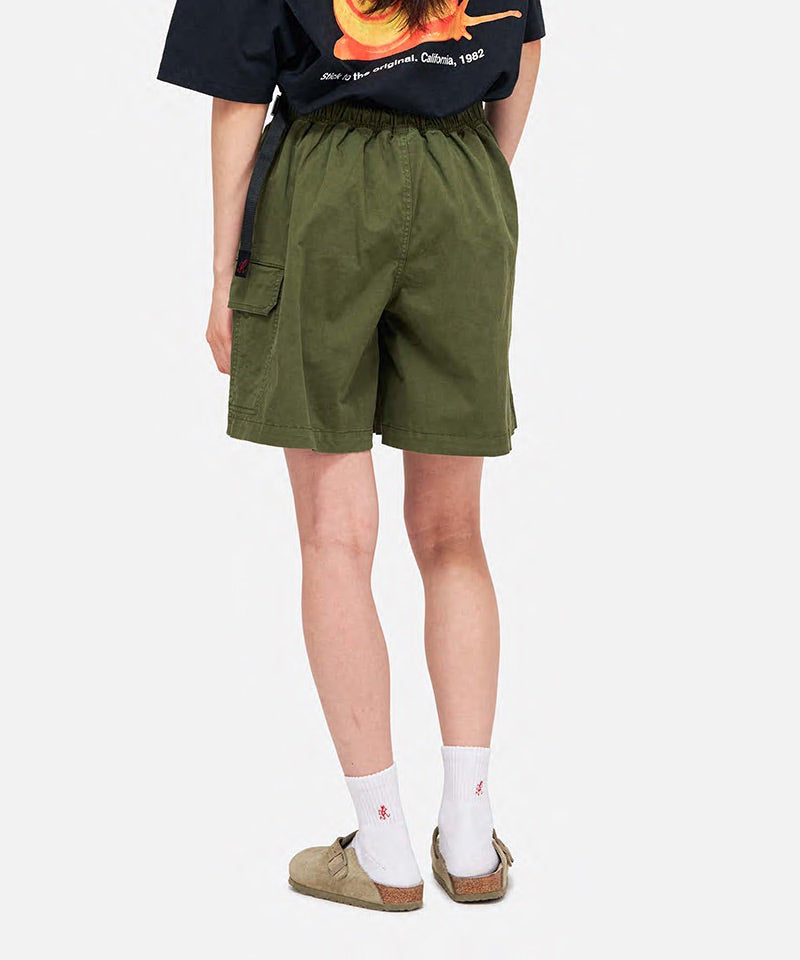 Model wearing a Gramicci G-Skort in the color olive and a black shirt on a light-tone background.