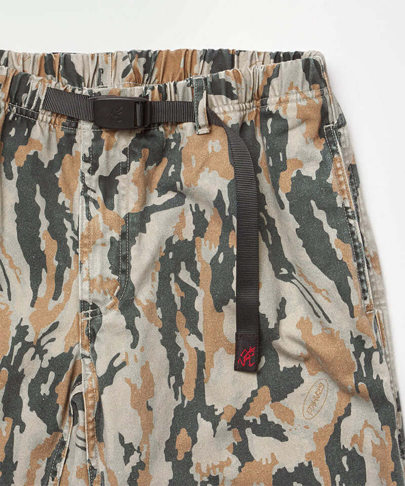 Close-up view of bark camo Denim Gramicci Pant Straight Fit on a light-tone background.