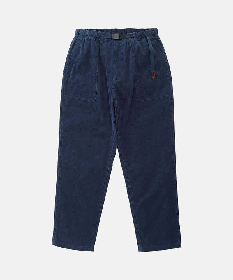 Dark navy Gramicci Corduroy Loose Tapered Ridge Pants with a belt against a light-tone background.