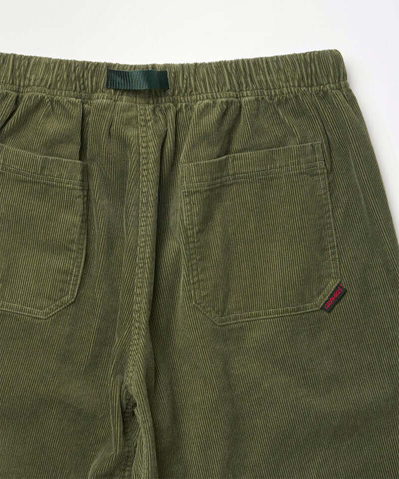 Close-up back view of toned olive colored Gramicci Corduroy Loose Tapered Ridge Pants on a light-tone background.