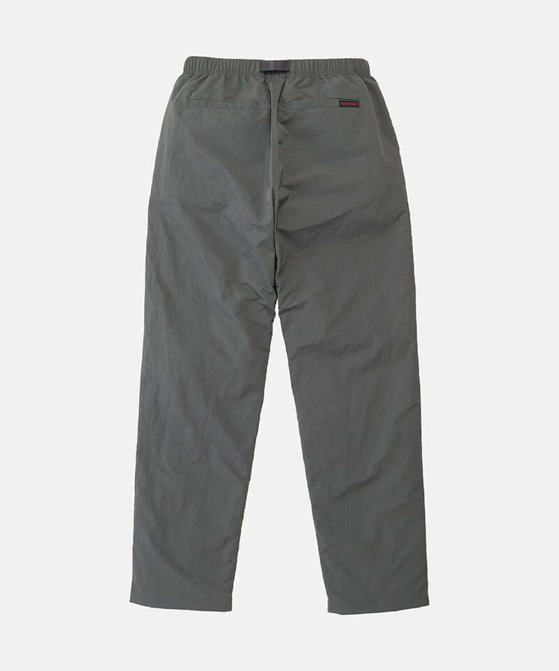 Back view of carbon colored Nylon Gramicci Pants on a light-tone background.
