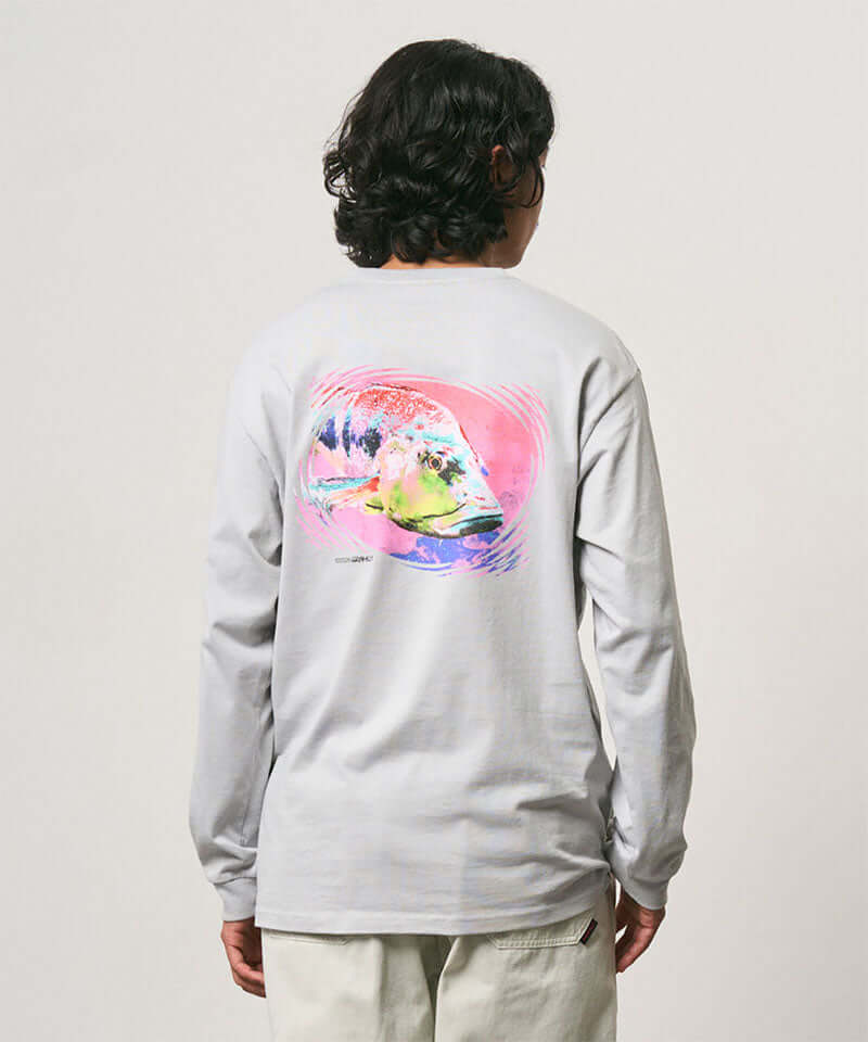 Back view of a model wearing a Gramicci mist colored Bass Long-Sleeve Tee with a graphic against a light-tone background.