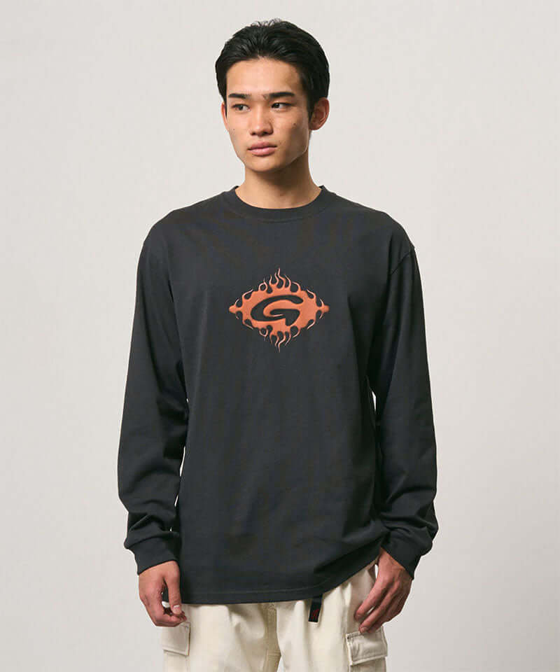 Model wearing a Gramicci vintage black Flames Long Sleeve Tee with a graphic against a light-tone background.