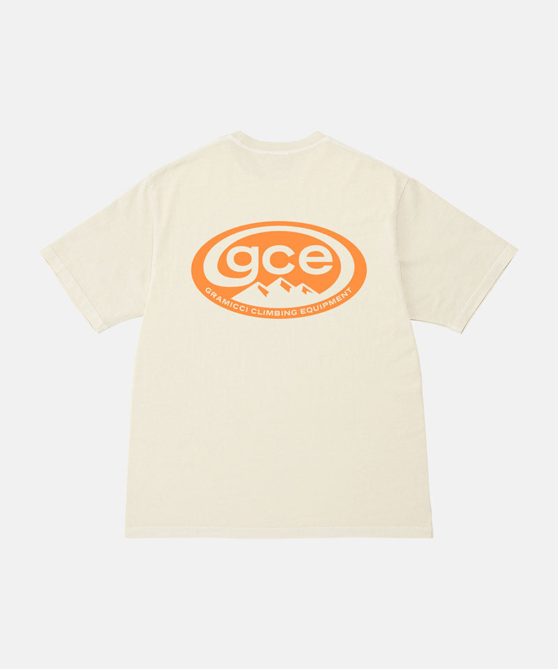 Back view of a Gramicci natural pigment colored GCE Tee Pigment Dyed with a graphic against a light-tone background.