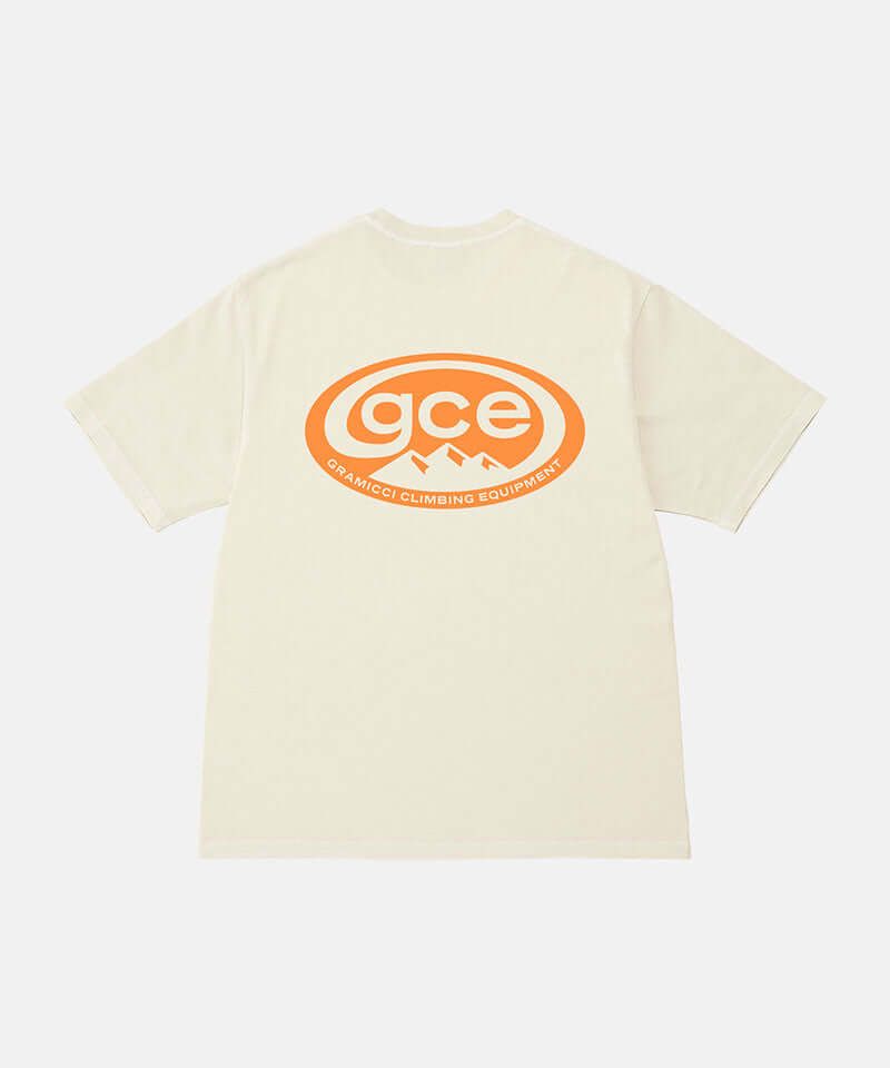 Back view of a Gramicci natural pigment colored GCE Tee Pigment Dyed with a graphic against a light-tone background.