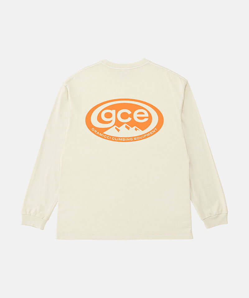 Back view of a Gramicci natural pigment colored GCE Long Sleeve Tee Pigment Dyed with a graphic against a light-tone background.