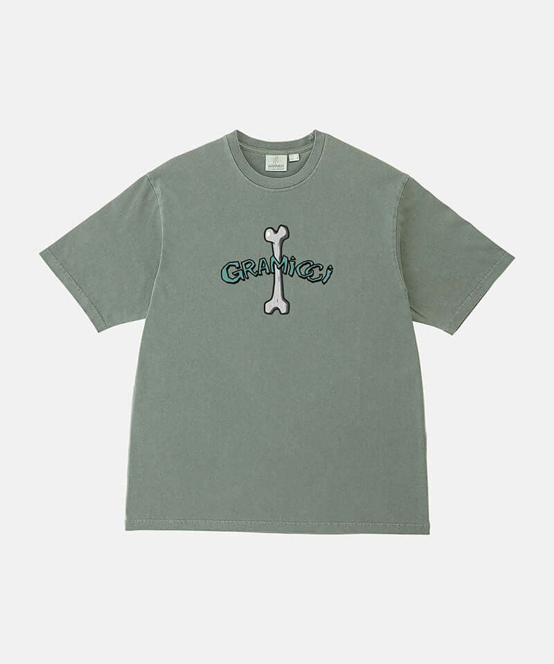 Gramicci sage pigment colored Bone Tee Pigment Dyed with a graphic against a light-tone background.