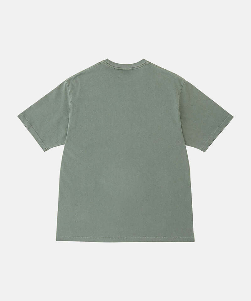Back view of a Gramicci sage pigment colored Bone Tee Pigment Dyed against a light-tone background.
