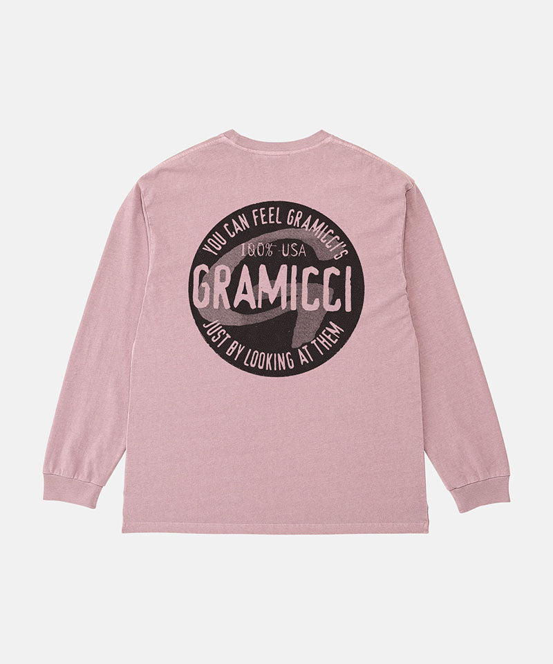 Back view of a Gramicci lilac pigment colored Icon Long Sleeve Tee Pigment Dyed with a graphic against a light-tone background.