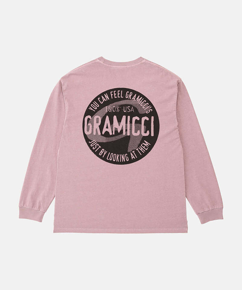 Back view of a Gramicci lilac pigment colored Icon Long Sleeve Tee Pigment Dyed with a graphic against a light-tone background.