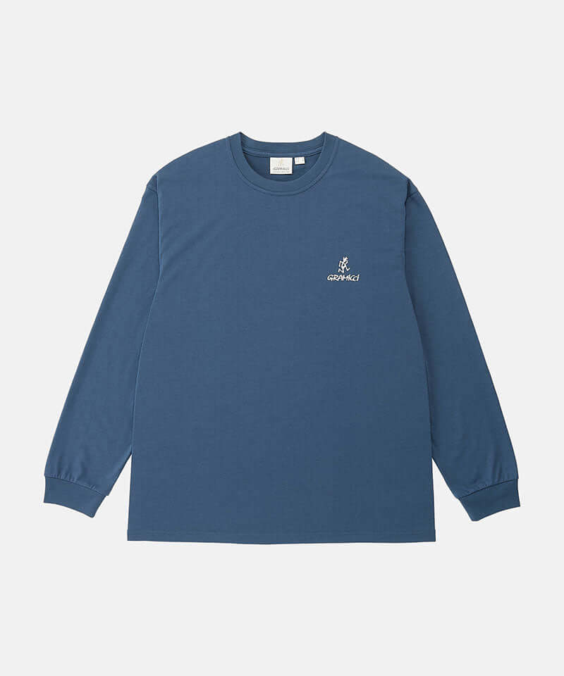 Model wearing a Gramicci dusky blue One Point Logo Long Sleeve Tee with a graphic against a light-tone background.