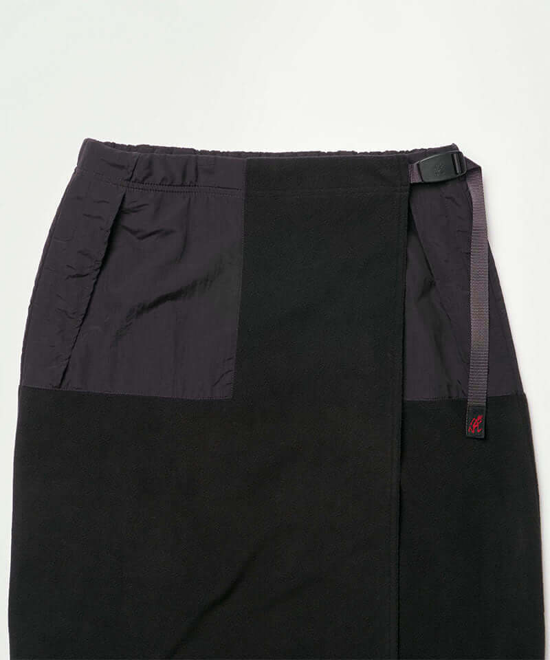 Close-up view of a black Gramicci Thermal Fleece Skirt against a light-tone background.