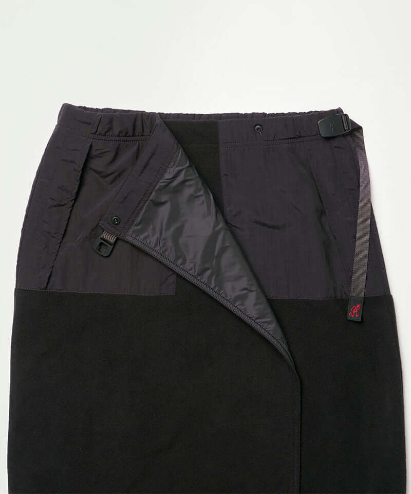 Close-up view of a black Gramicci Thermal Fleece Skirt against a light-tone background.