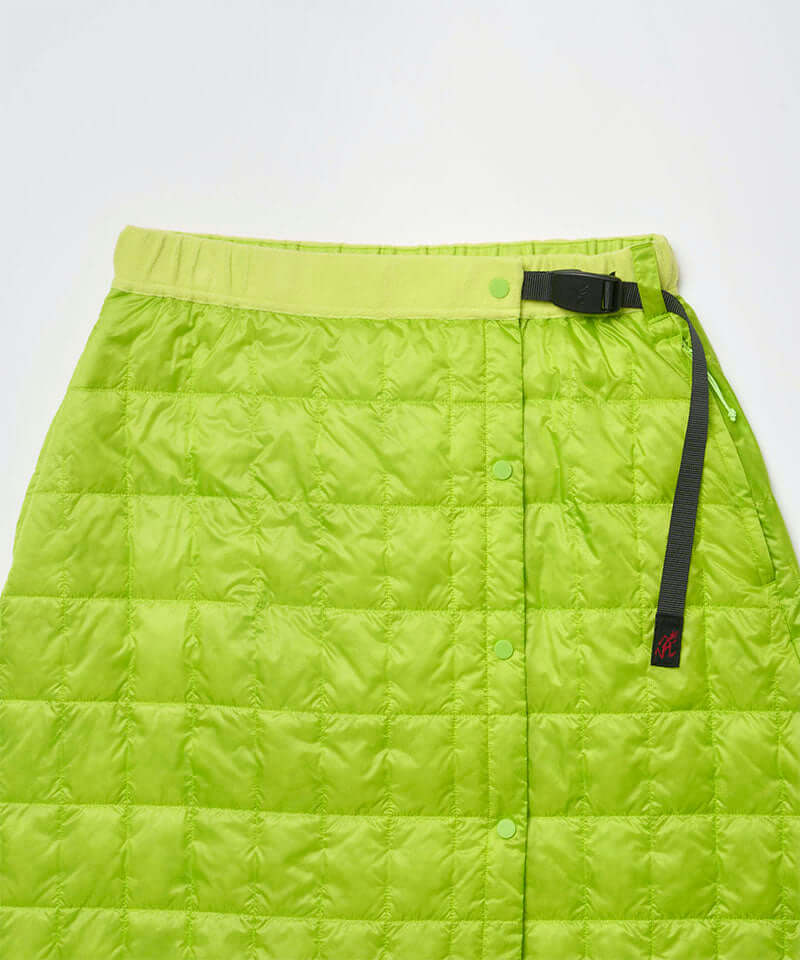 Close-up view of a lime colored Gramicci G-Zero Primaloft Skirt against a light-tone background.