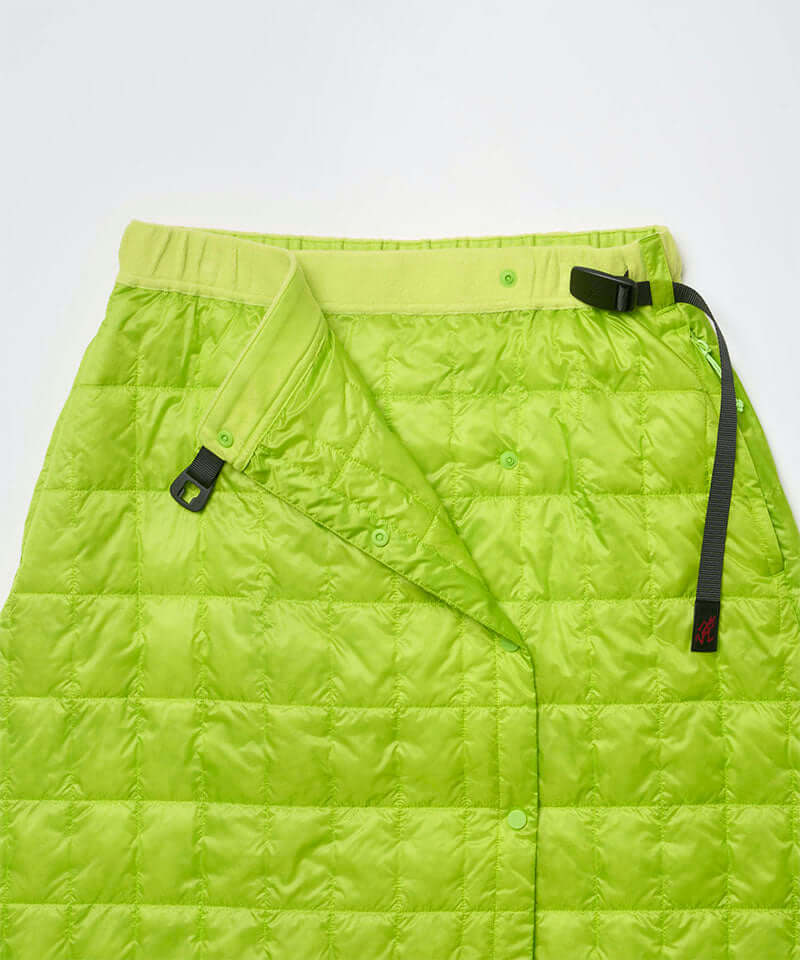 Close-up view of a lime colored Gramicci G-Zero Primaloft Skirt against a light-tone background.