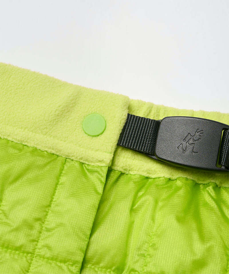 Close-up view of a lime colored Gramicci G-Zero Primaloft Skirt against a light-tone background.