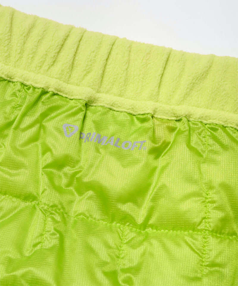 Close-up view of a lime colored Gramicci G-Zero Primaloft Skirt against a light-tone background.
