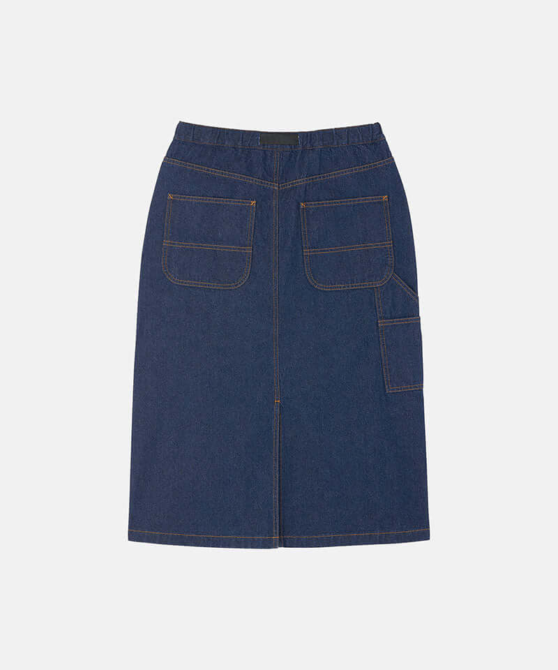 Back view of a rinsed indigo Gramicci Denim Carpenter Skirt against a light-tone background.