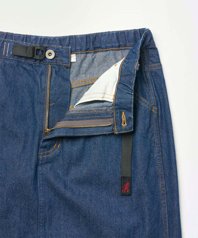 Close-up of the waistband on a stone colored Gramicci Gramicci Denim Carpenter Skirt on a light-tone background.