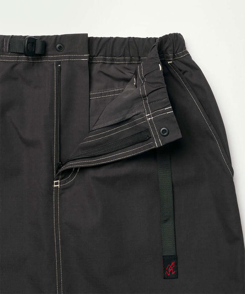 Close-up of the waistband on a black Gramicci women's Gramicci WR Convertible Skirt on a light-tone background.