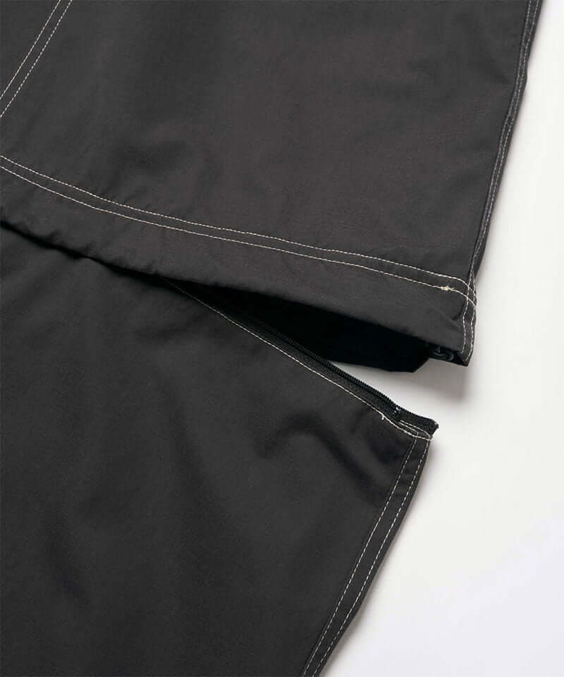 Close-up view of a black women's Gramicci WR Convertible Skirt against a light-tone background.