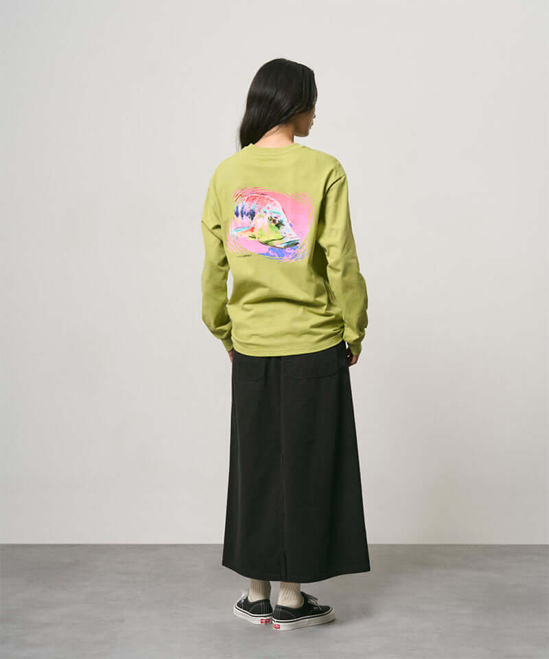 Back view of a model wearing a black Gramicci 5-Pocket Skirt and a lime green shirt on a light-tone background.