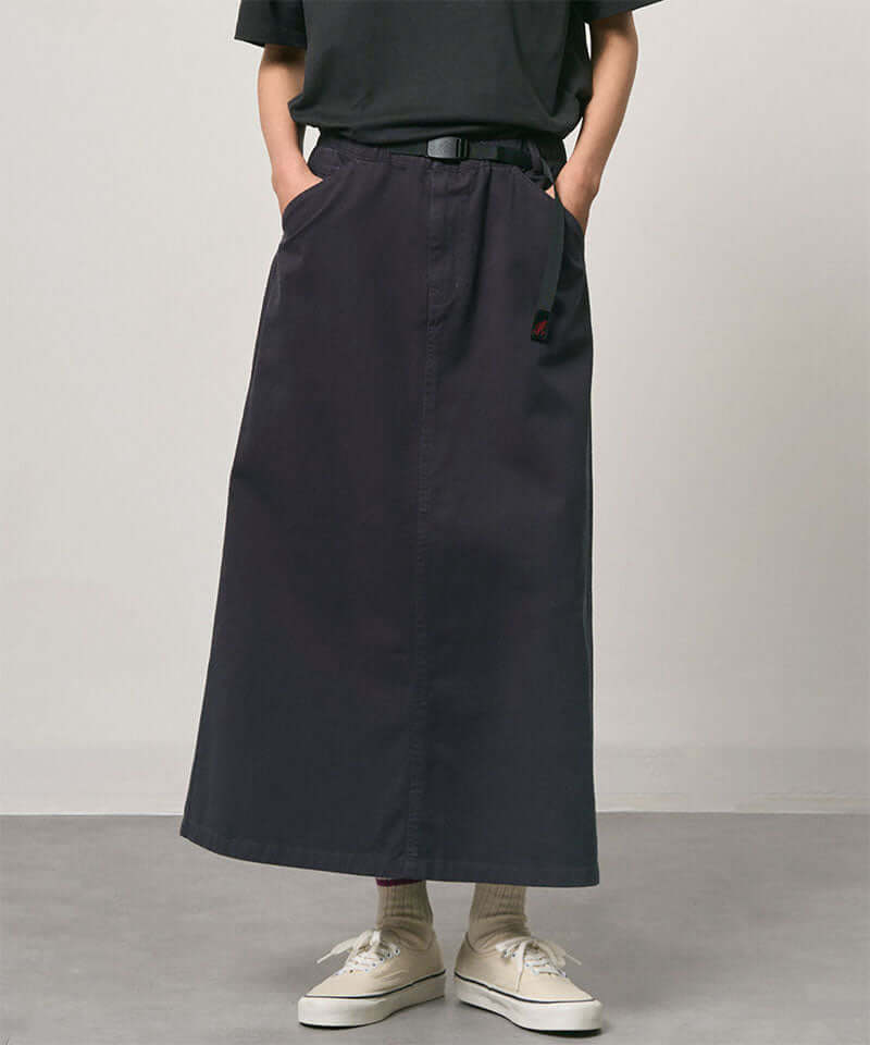 Model wearing a double navy Gramicci 5-Pocket Skirt and a black shirt on a light-tone background.
