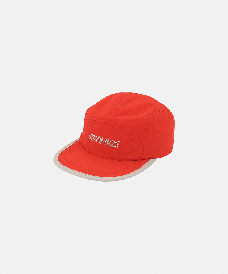 Orange cap with 'Gramicci' logo on a light tone background