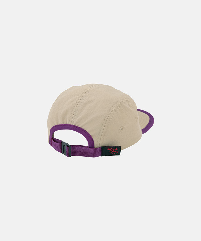 Back view of a milk tea beige colored Nylon Gramicci Cap with a purple brim on a light tone background.