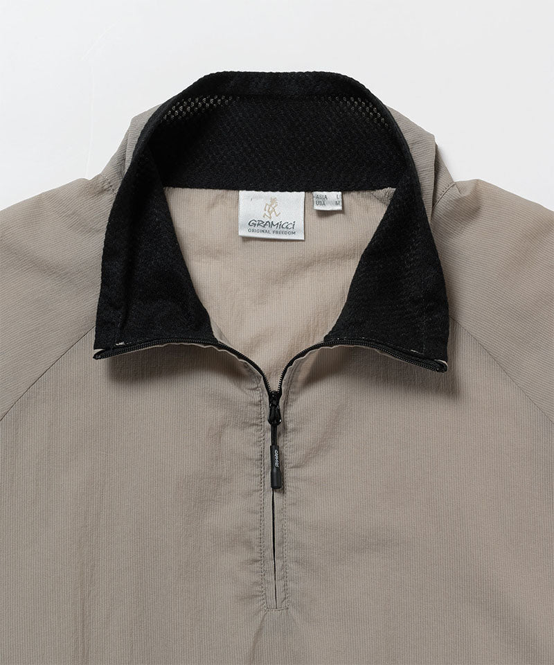 Gramicci concrete colored Ultra-Light Packable Jacket collar detail against a light-tone background.