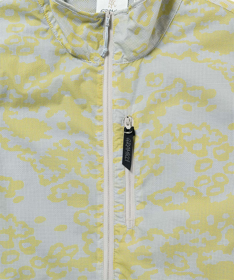 Close-up of a yellow and gray patterned jacket with a zipper and brand logo.