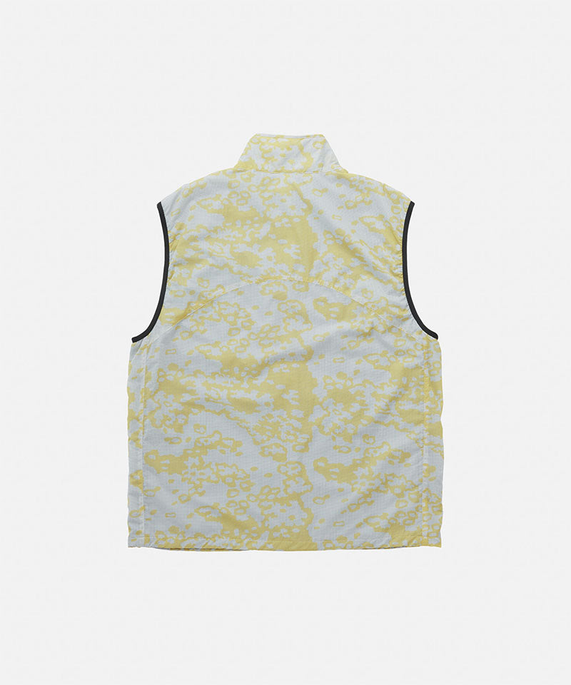 Yellow and white patterned sleeveless top on a light gray background