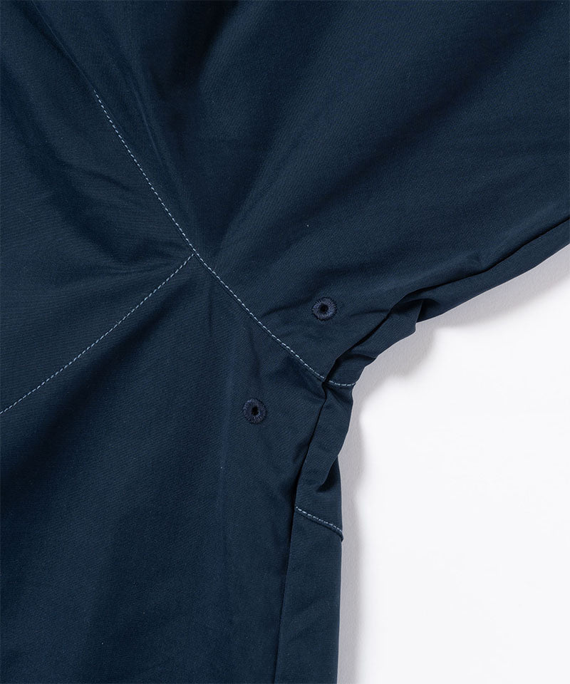 Close-up of a dark navy Gramicci Milton Hooded Jacket on a light-tone background.