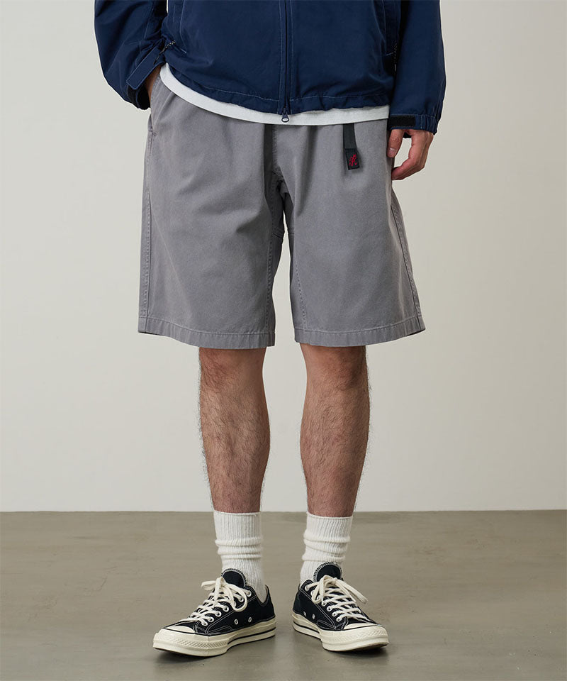 Model wearing a Gramicci Natural Dyed Jam Short in the color grey on a light-tone background.