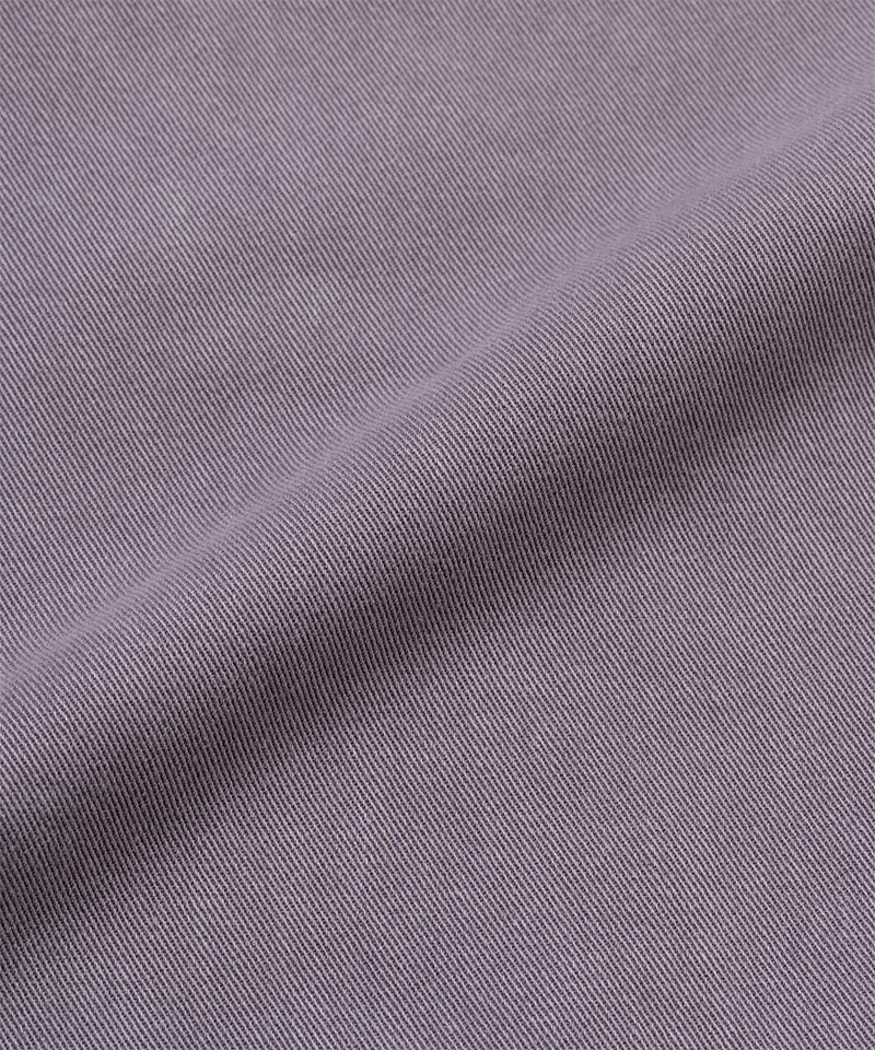 Close-up of Gramicci Natural Dyed purple fabric with a subtle pattern