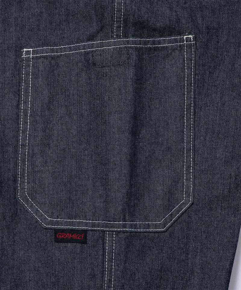 Back view close-up of Japanese Chambray Rock Slide Pants pocket in the color navy against a light-tone background.
