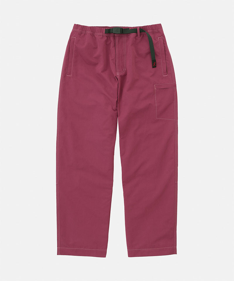 Gramicci Milton Pants in burgundy with a black belt against a light-tone background.
