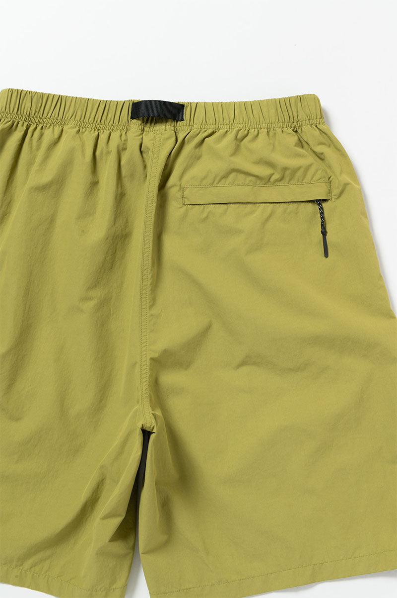 Green shorts with a pocket and zipper on a white background