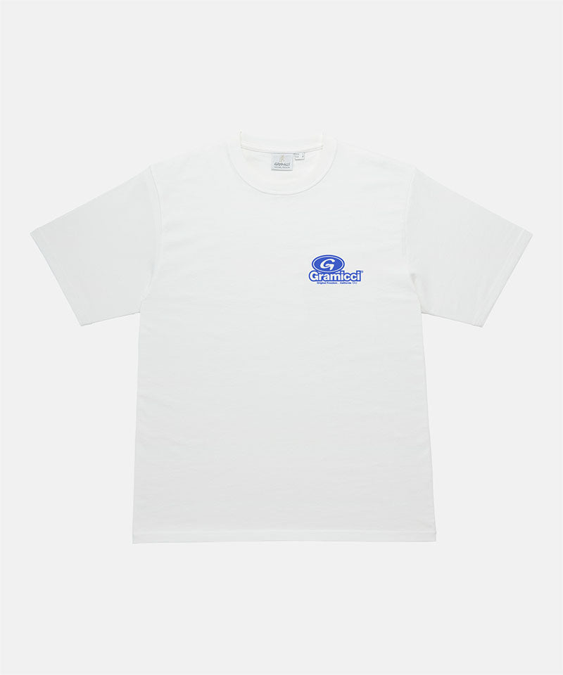 Gramicci white '82 Tee with blue graphic against a light tone background.