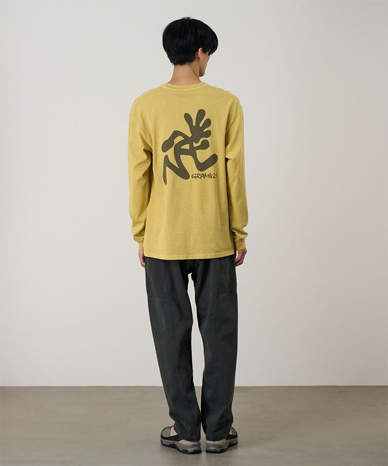 Back view of a model wearing a sulpher pigment Gramicci Running Man L/S Tee Pigment Dyed with a grey graphic and dark pants on a light-tone background.