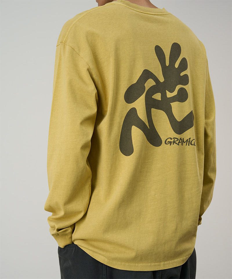 Back view of a model wearing a Gramicci sulpher pigment Running Man L/S Tee Pigment Dyed with a grey graphic against a light-tone background.