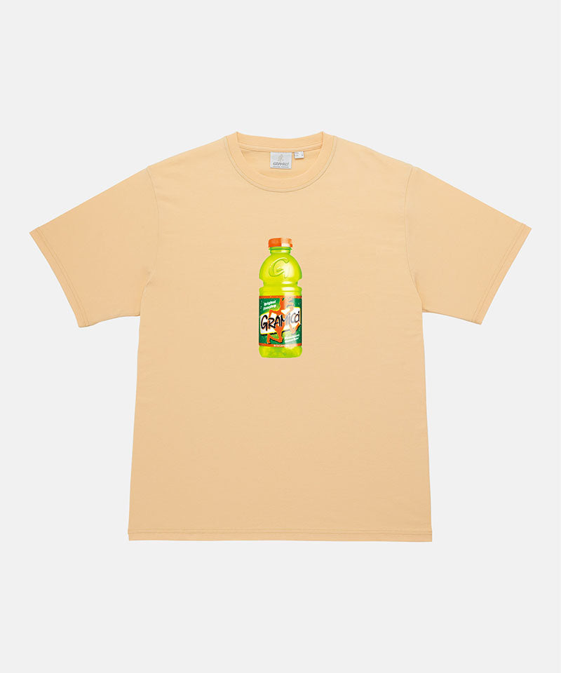 Gramicci mango colored Quencher Tee with black graphic against a light-tone background.
