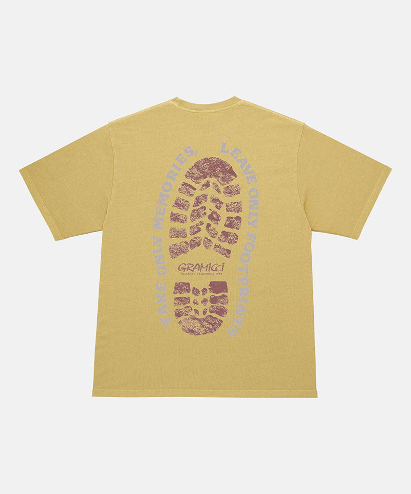 Back view of a Gramicci sulpher yellow Footprints Tee Pigment Dyed with red graphic against a light tone background.